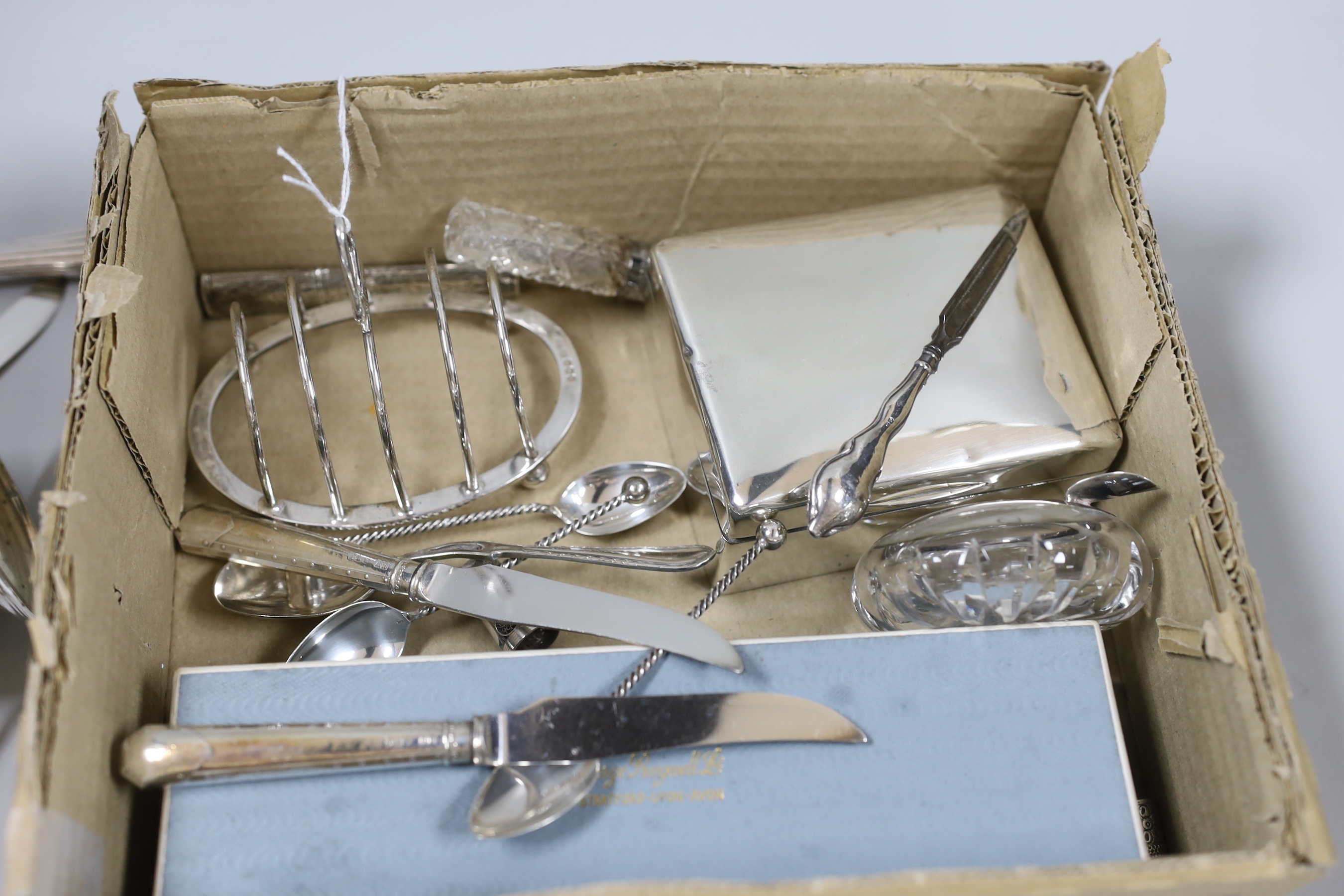 A small group of sundry small silver including a set of four napkin rings, cigarette box, sugar bowl, toastrack, scent bottle, 19th century white metal needle case, Egyptian white metal dishes and assorted flatware inclu